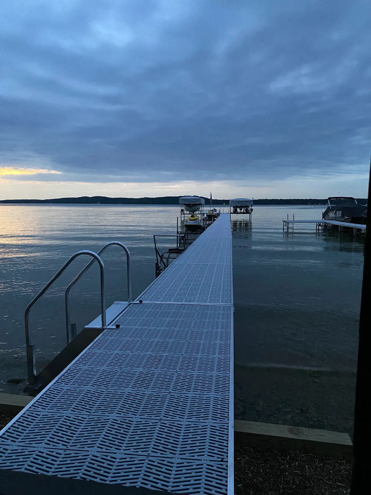 a dock with stairs leading to a body of water