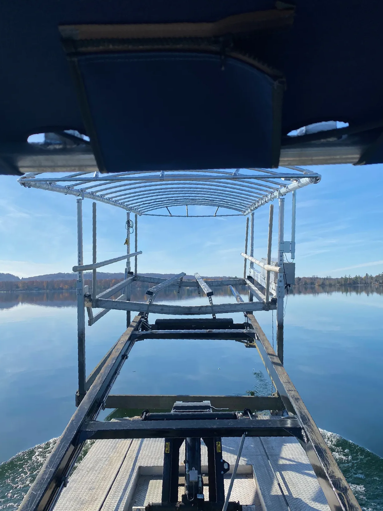 a boat is going down a dock into a lake