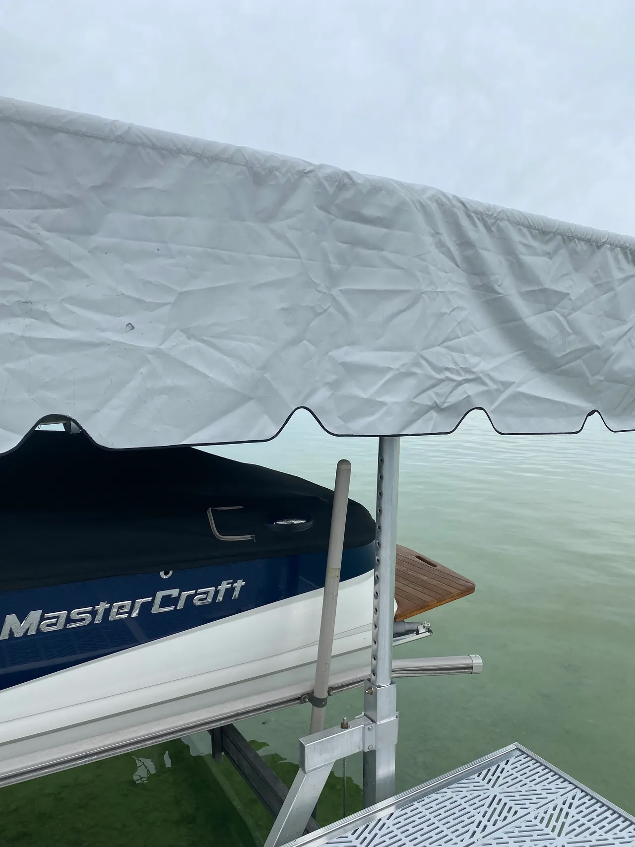 a boat is sitting on top of a dock under a canopy .
