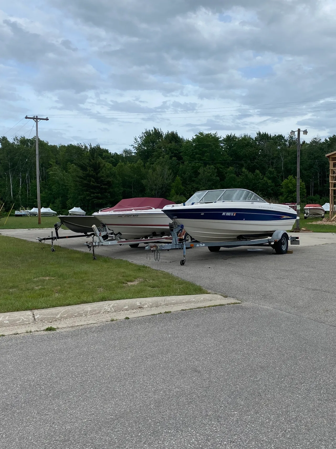 a couple of boats are parked on the side of the road