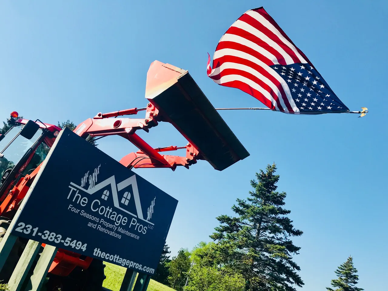 an american flag is flying over a sign that says the cottage pros