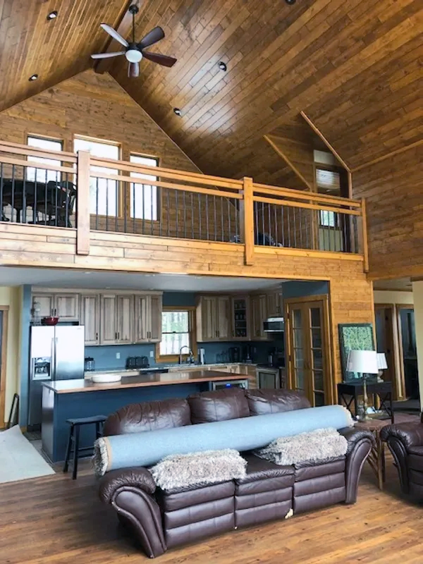 a living room with a couch and a ceiling fan