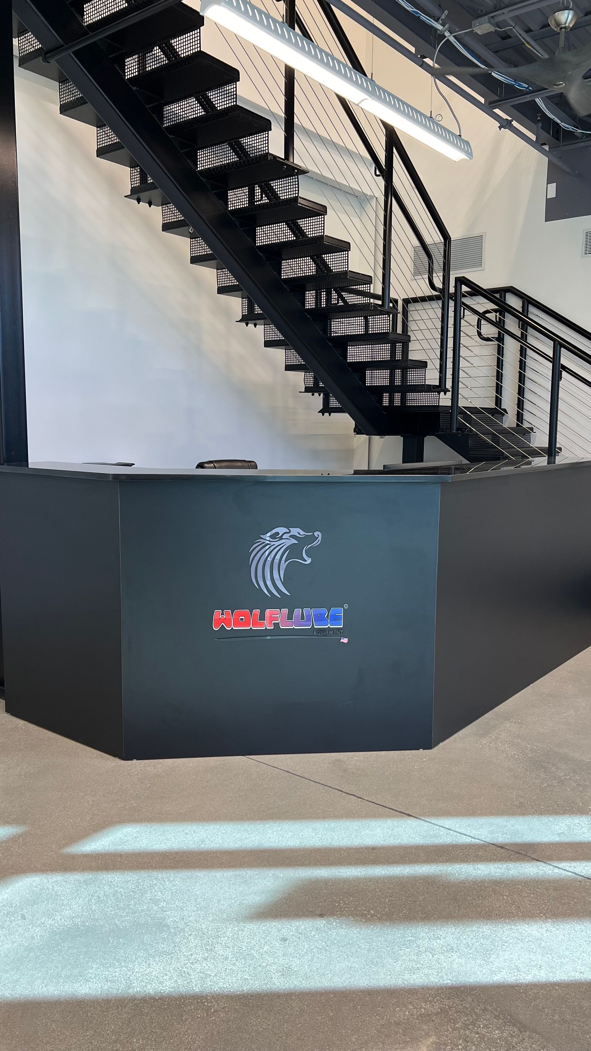 A black reception desk with a circular logo and the text 