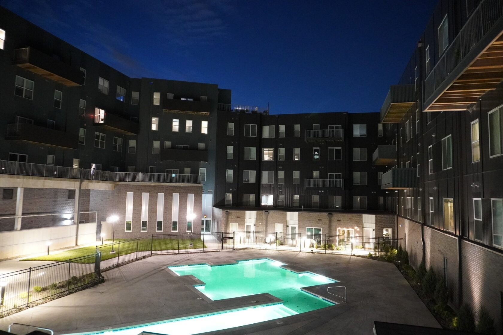A large building with a swimming pool in front of it