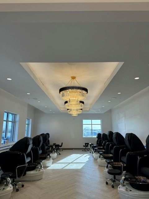 A large room filled with chairs and a chandelier