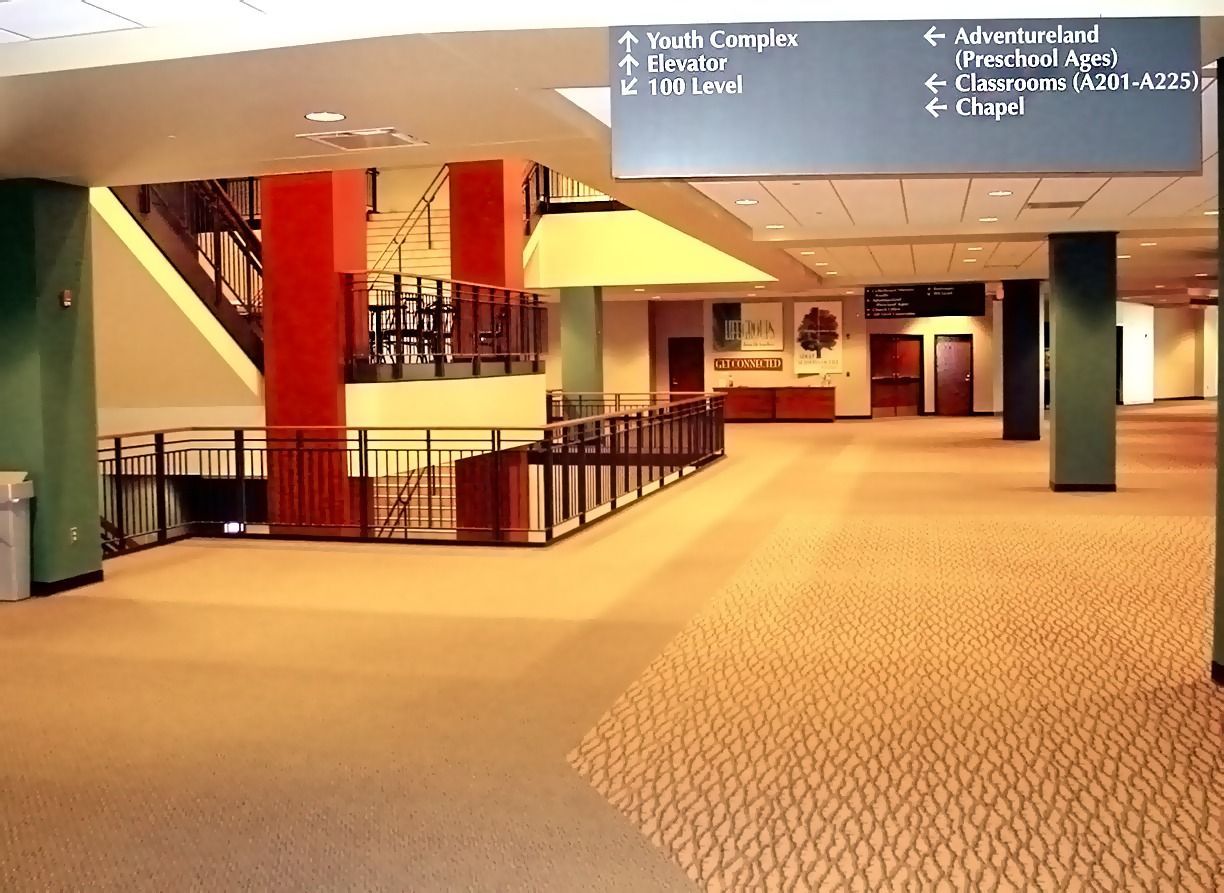A large hallway with a sign that says ' admissions ' on it