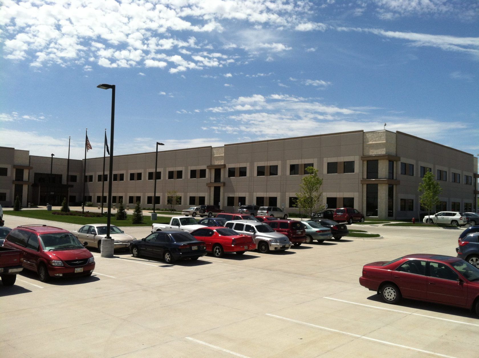 A large building with a lot of cars parked in front of it