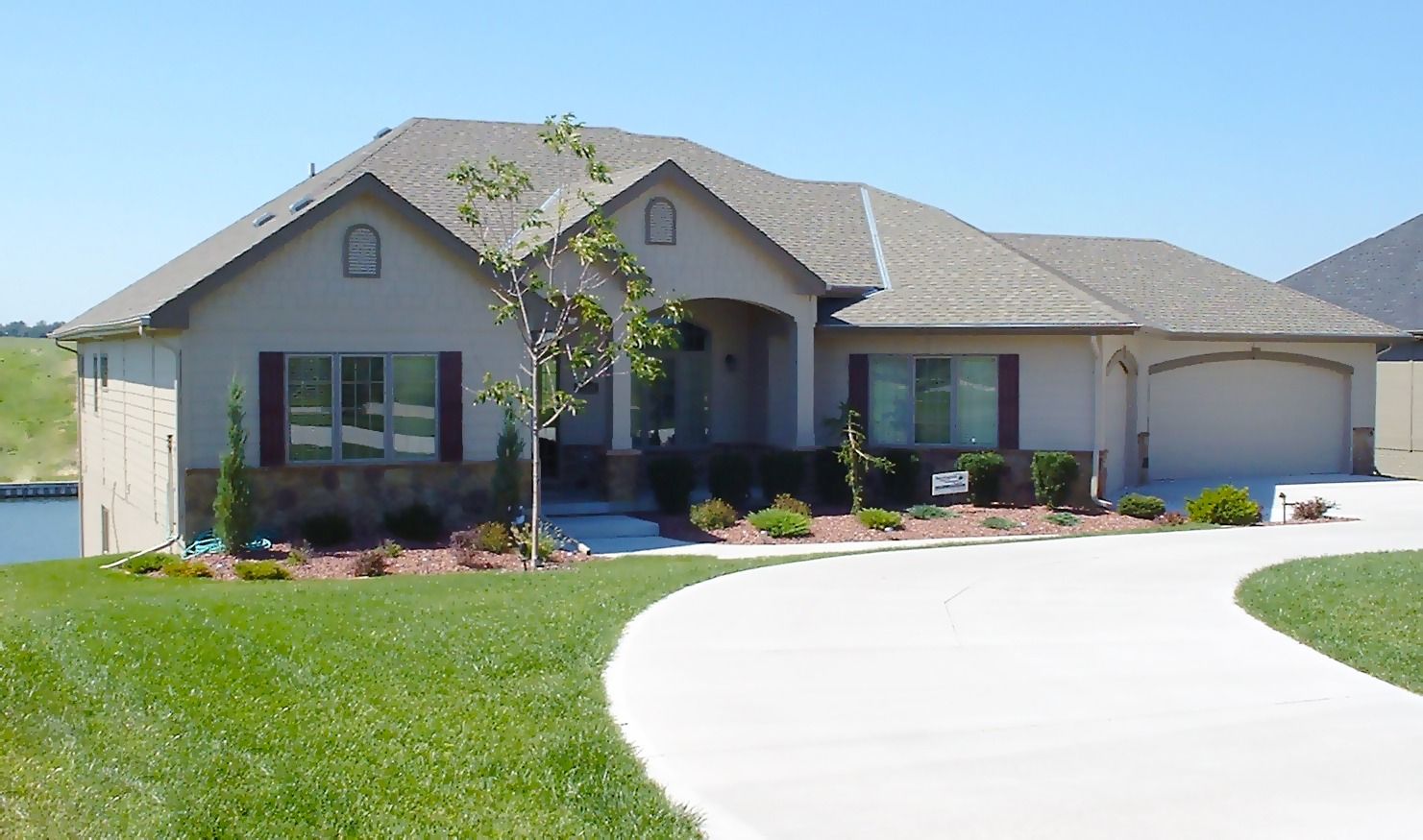 A house with a concrete driveway leading to it