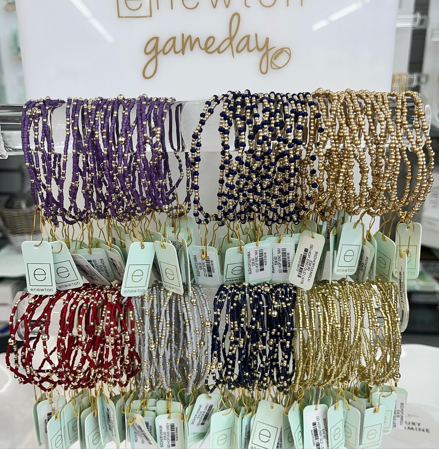 A display of bracelets with a sign that says gameday.