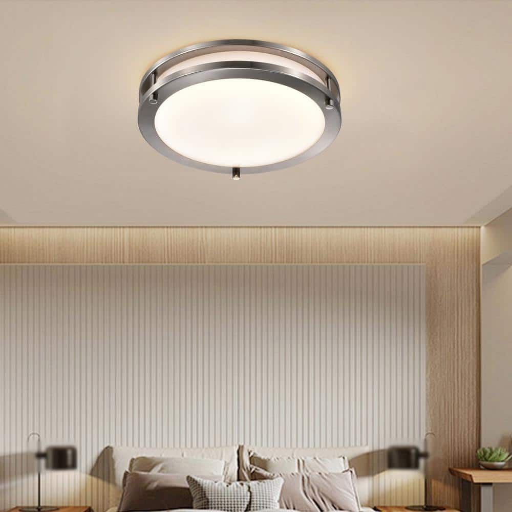 A bedroom with a ceiling light above a bed.