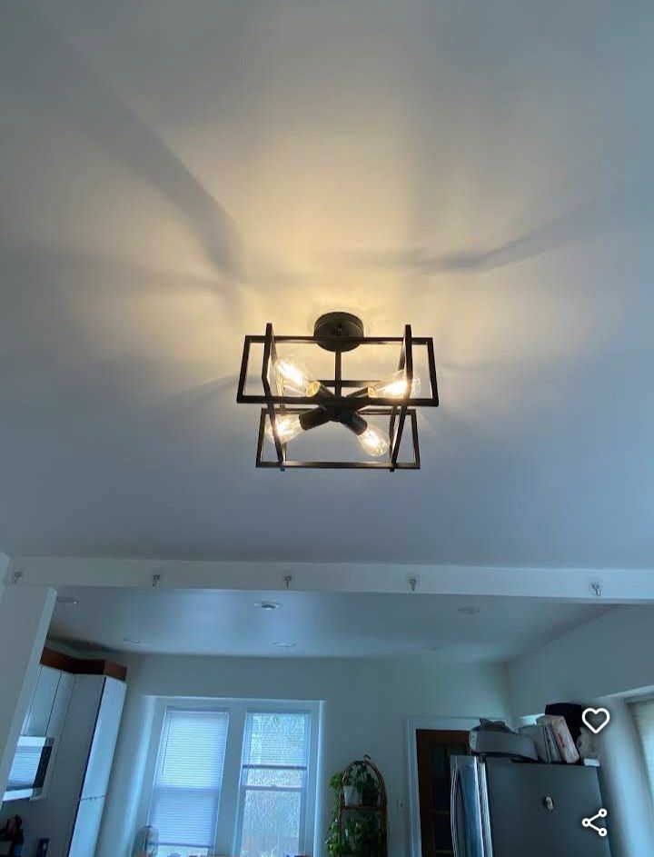A light is hanging from the ceiling in a living room