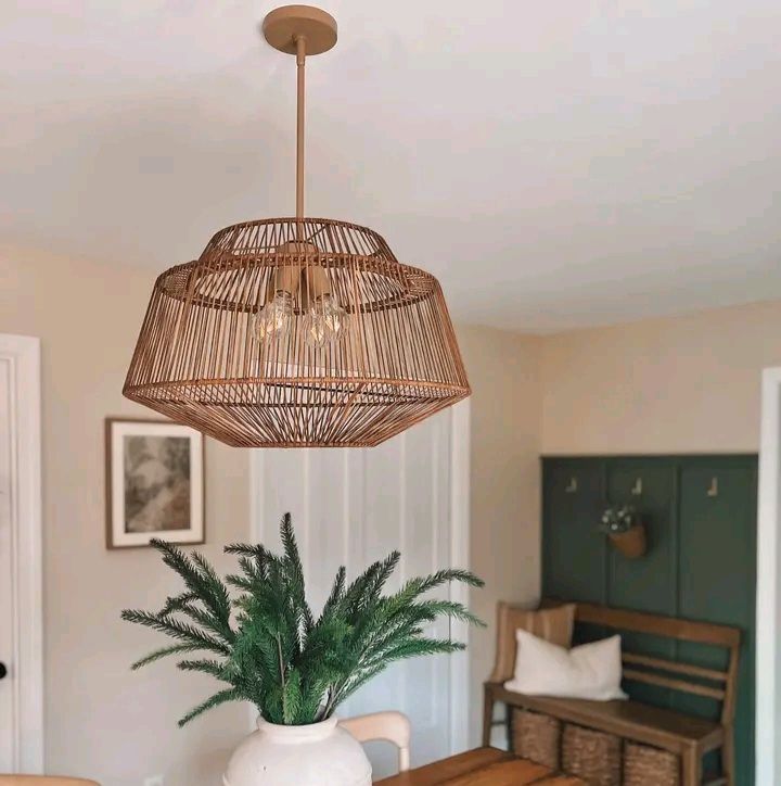 A dining room with a wicker chandelier hanging from the ceiling