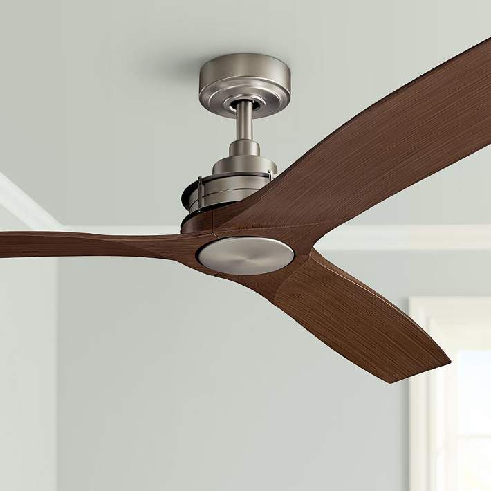 A ceiling fan with wooden blades is hanging from the ceiling in a room.
