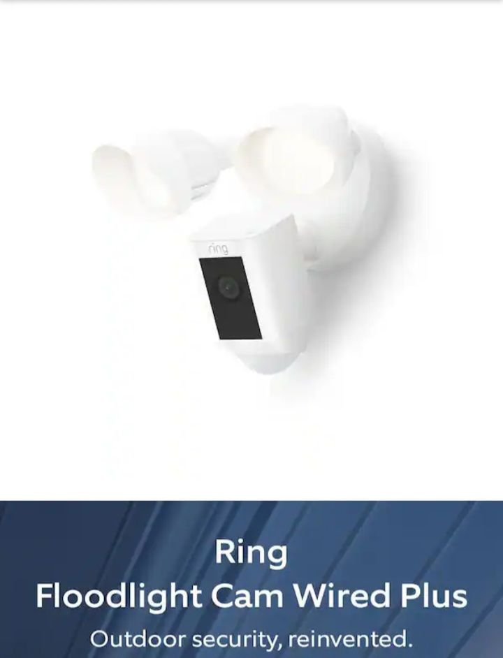 Ring Floodlight Cam Wired Plus security camera with twin white floodlights on white background