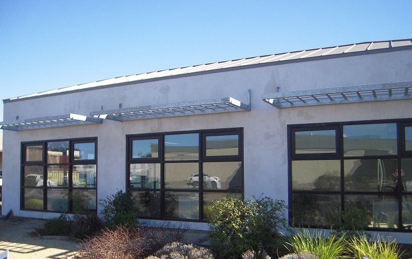 A building with a lot of windows and a blue sky in the background