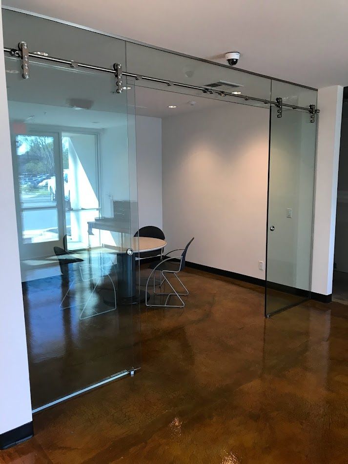 A room with sliding glass doors and a table and chairs.