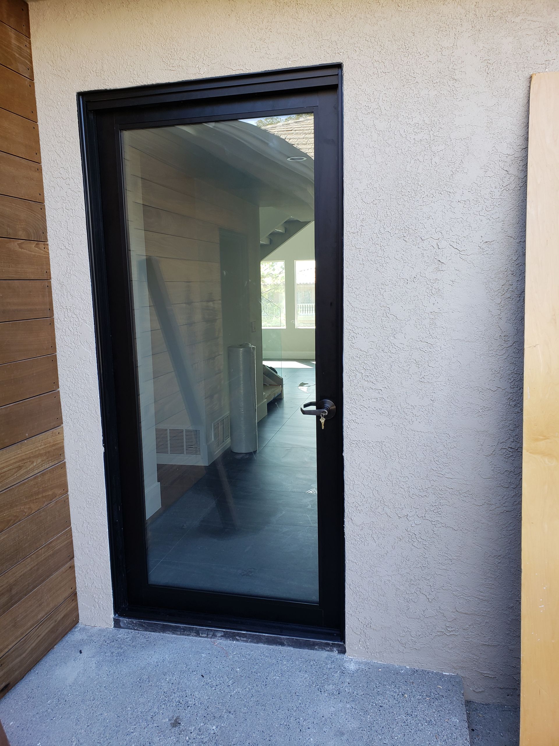 A door with a black frame is open to a room