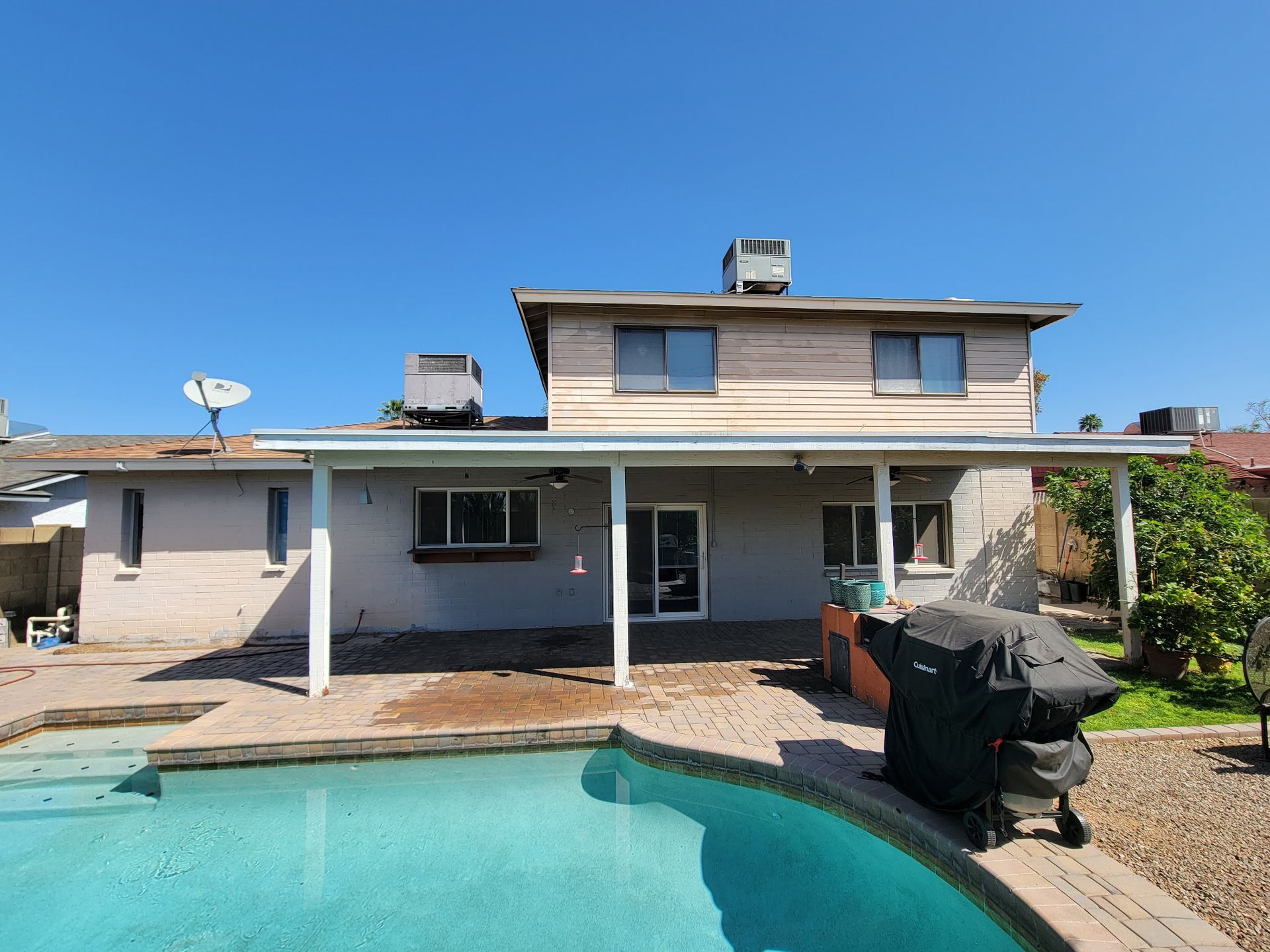 A house with a swimming pool in front of it