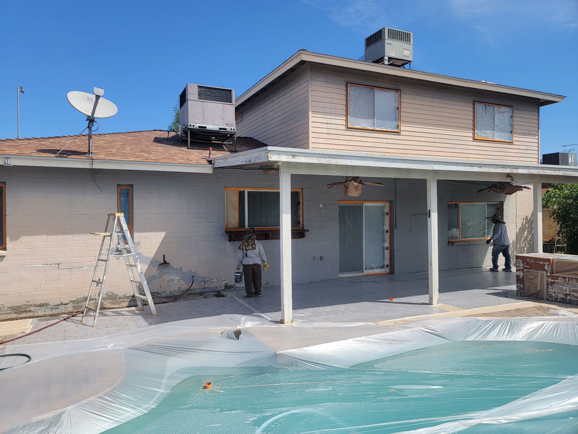 A house with a patio and a pool in front of it
