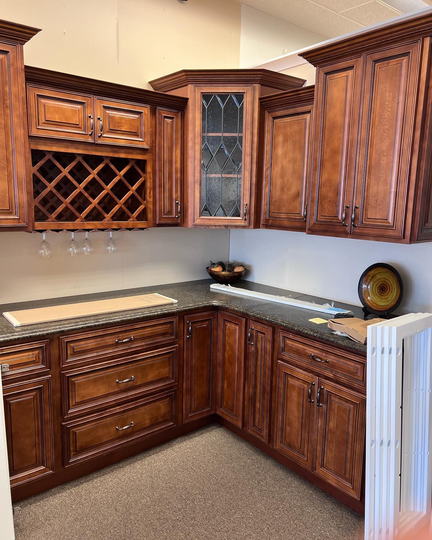a kitchen with wooden cabinets and granite counter tops .