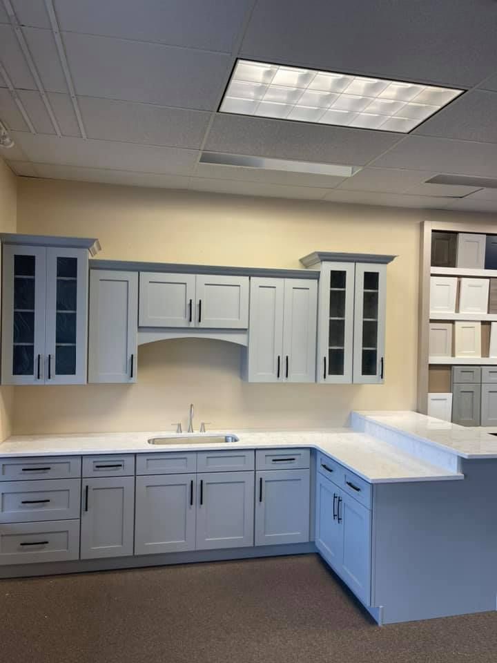 a kitchen with white cabinets and a sink in it