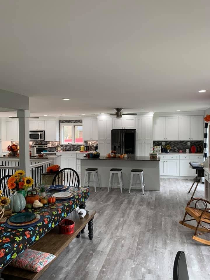 a kitchen and dining room in a house with a table and chairs .