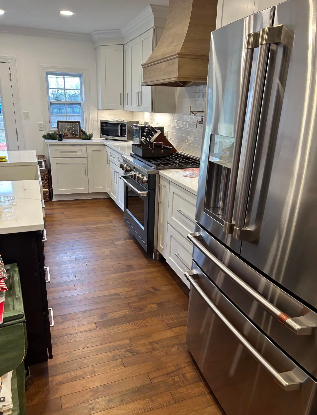 a kitchen with stainless steel appliances and white cabinets .