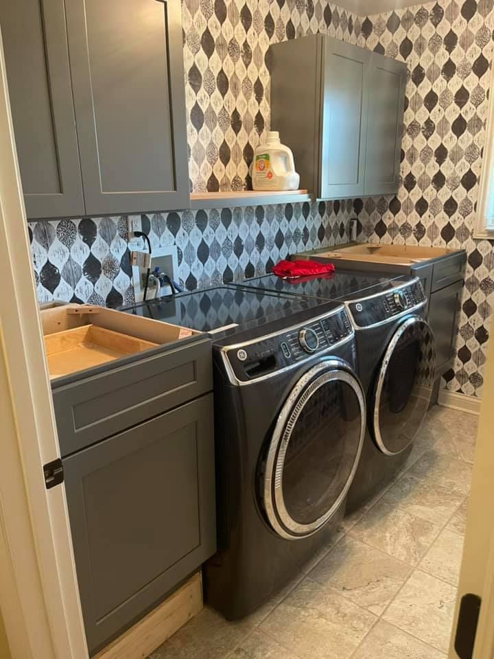 a laundry room with a washer and dryer and a sink .