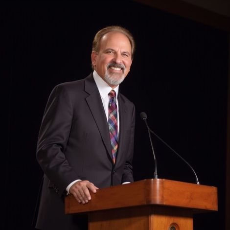 Man in suit at a podium