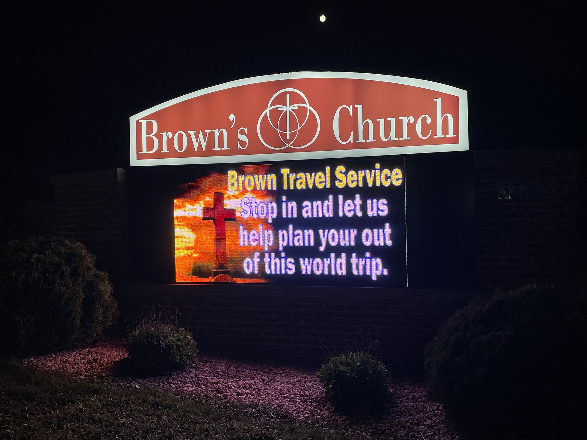 LED sign that says Brown Travel Service