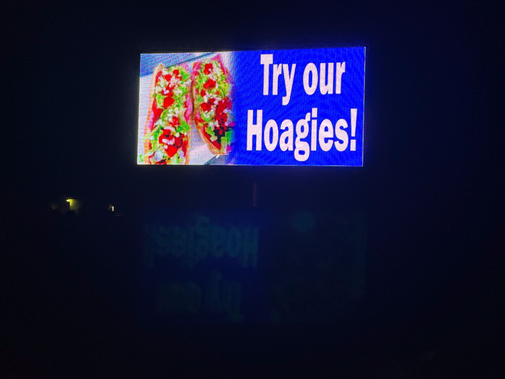 LED sign that says Try our Hoagies