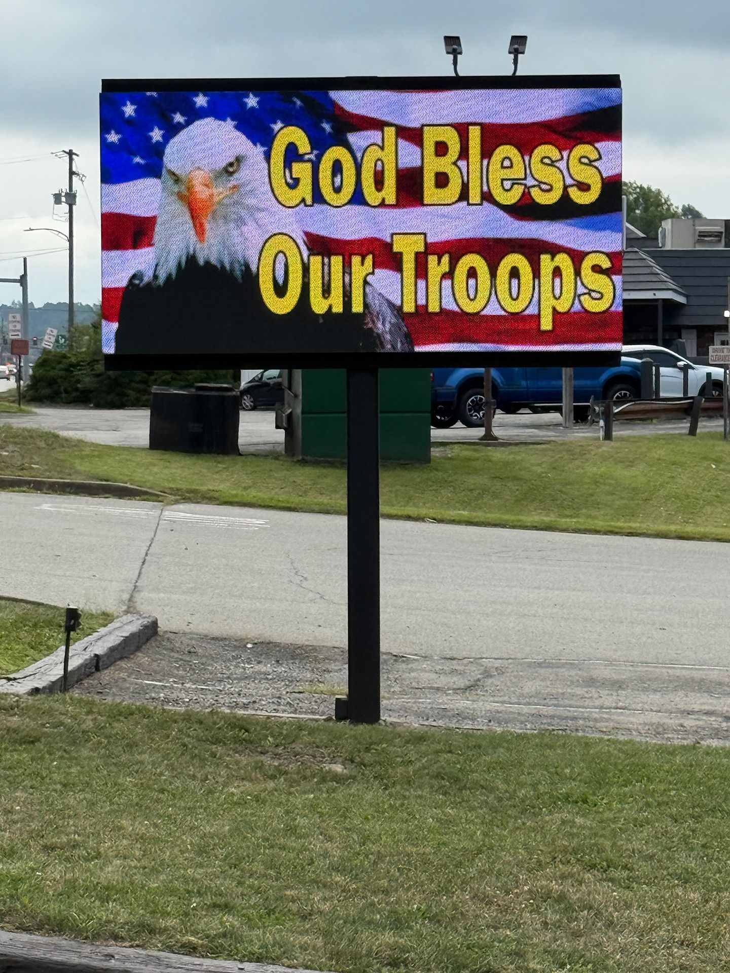 Street LED sign that says God Bless Our Troops