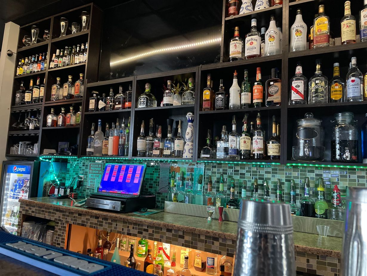A table topped with a variety of drinks with straws in them