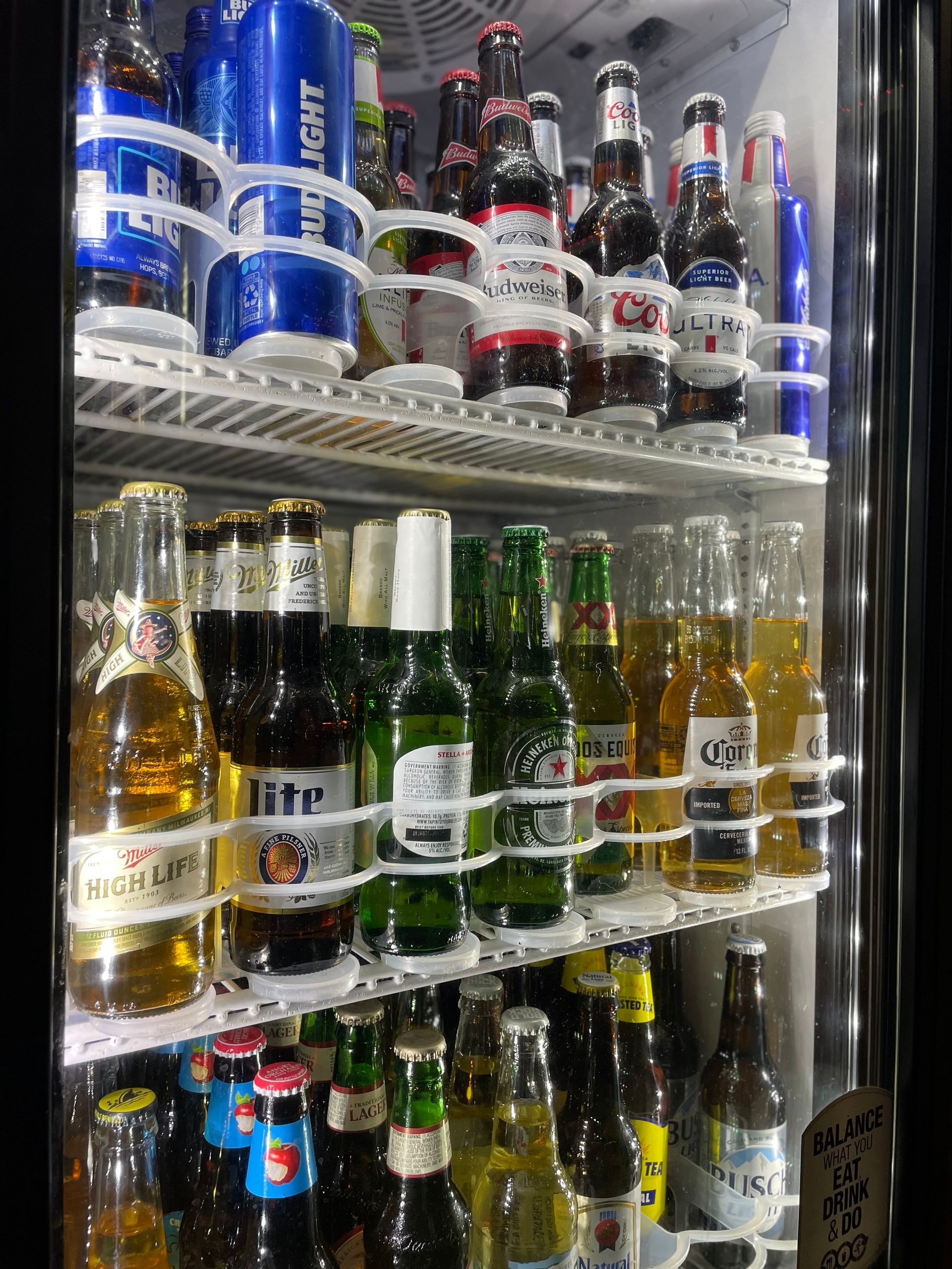 A refrigerator filled with bottles and cans of beer