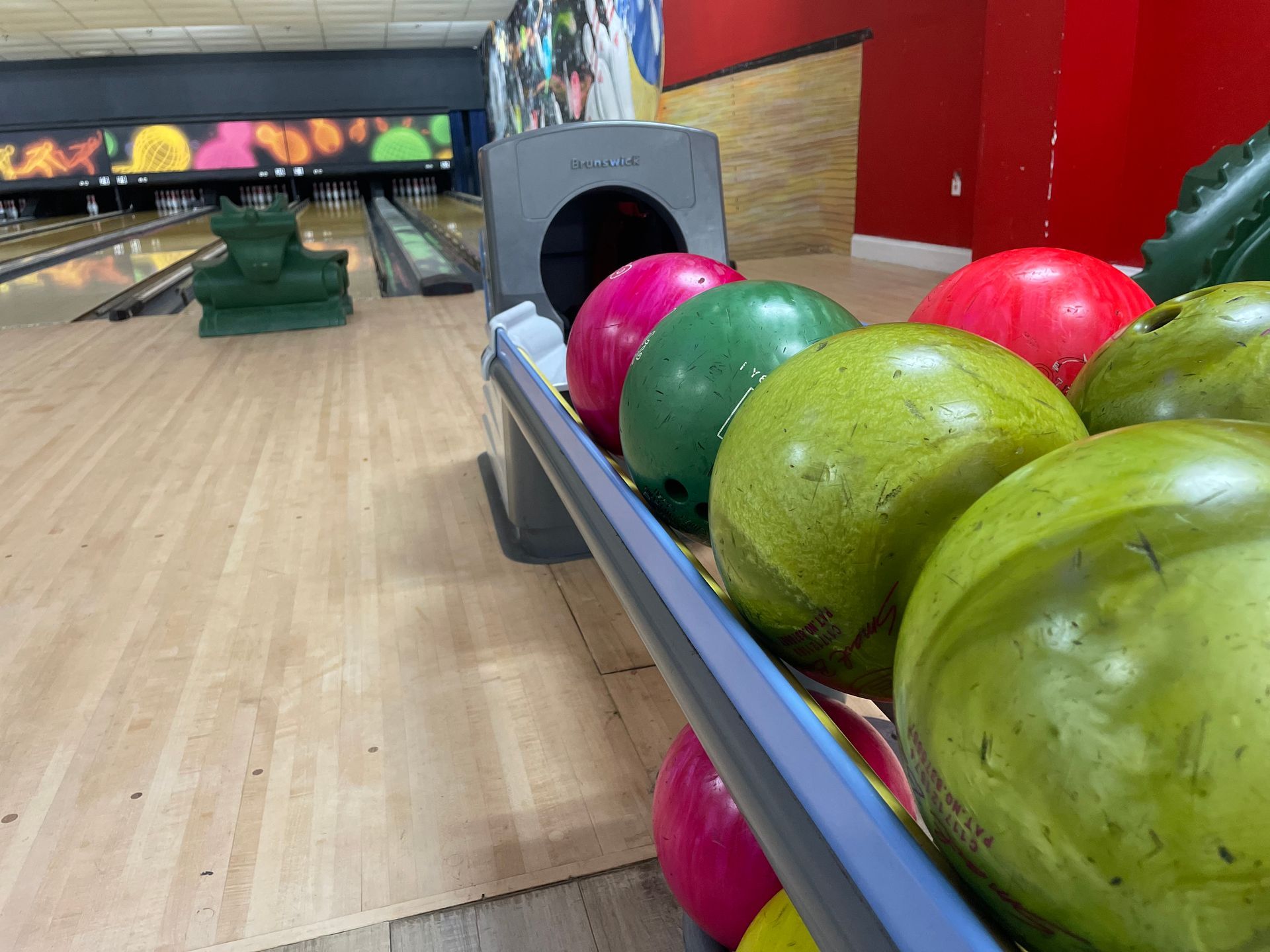 A bowling alley filled with bowling balls of different colors
