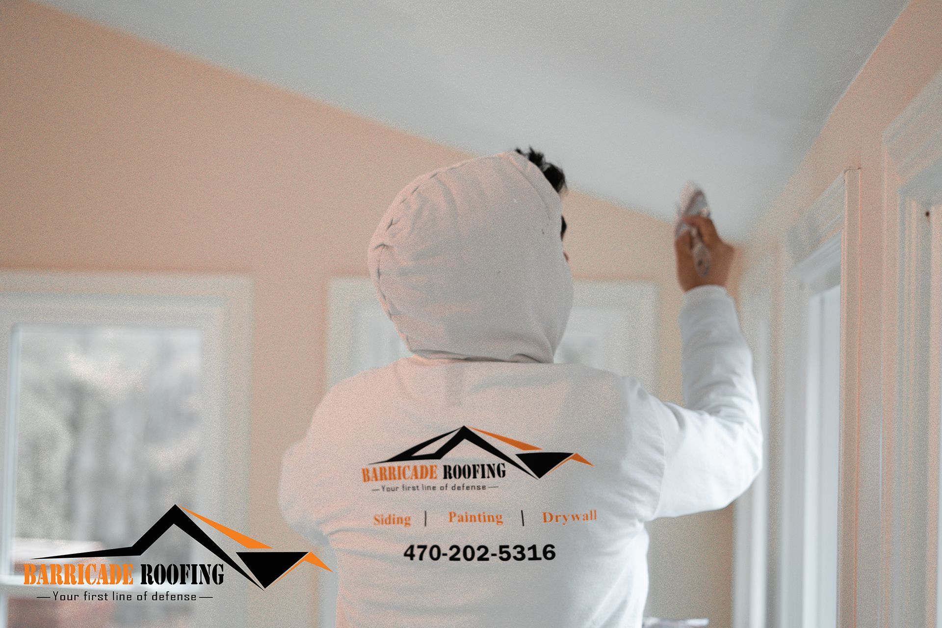 Person in protective suit painting interior trim. Building interior with windows. Contact info on back.