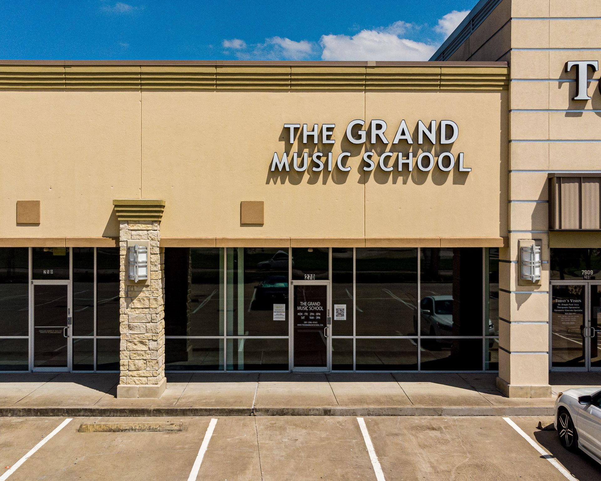 A car is parked in front of the grand music school