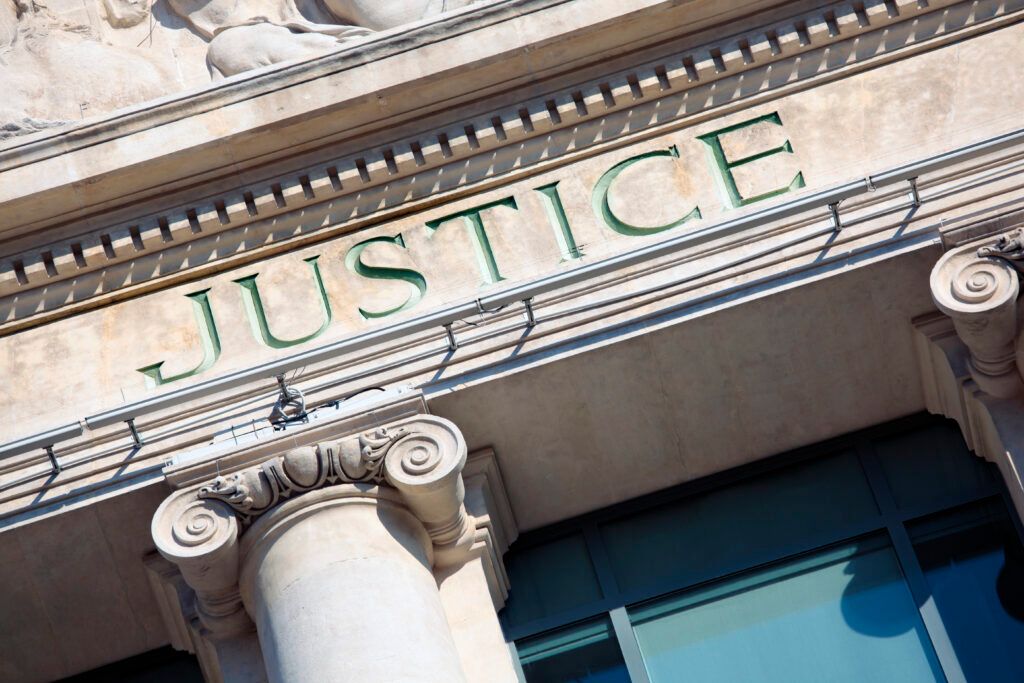 The word justice is on the front of a building