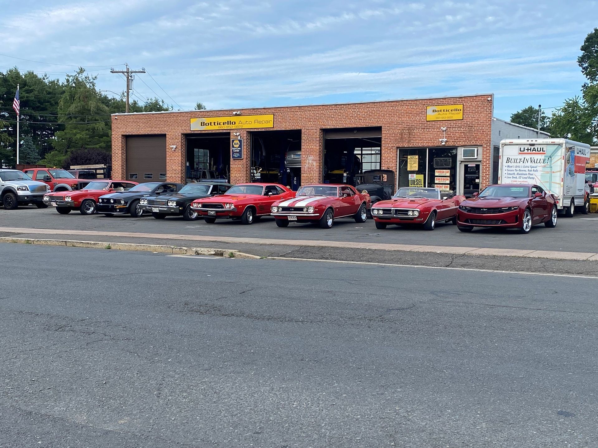 A row of cars is parked in front of Botticello Auto Repair 