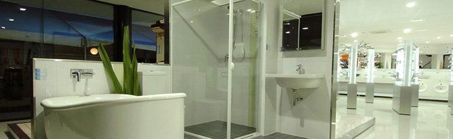 A bathroom with glass enclosed shower