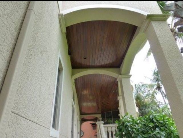 Clean exterior entryway with wood ceiling
