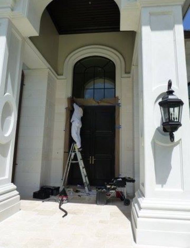 Clean residential entryway with arched window and columns