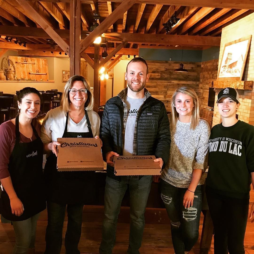 A group of people are posing for a picture and one of them is wearing a patagonia jacket