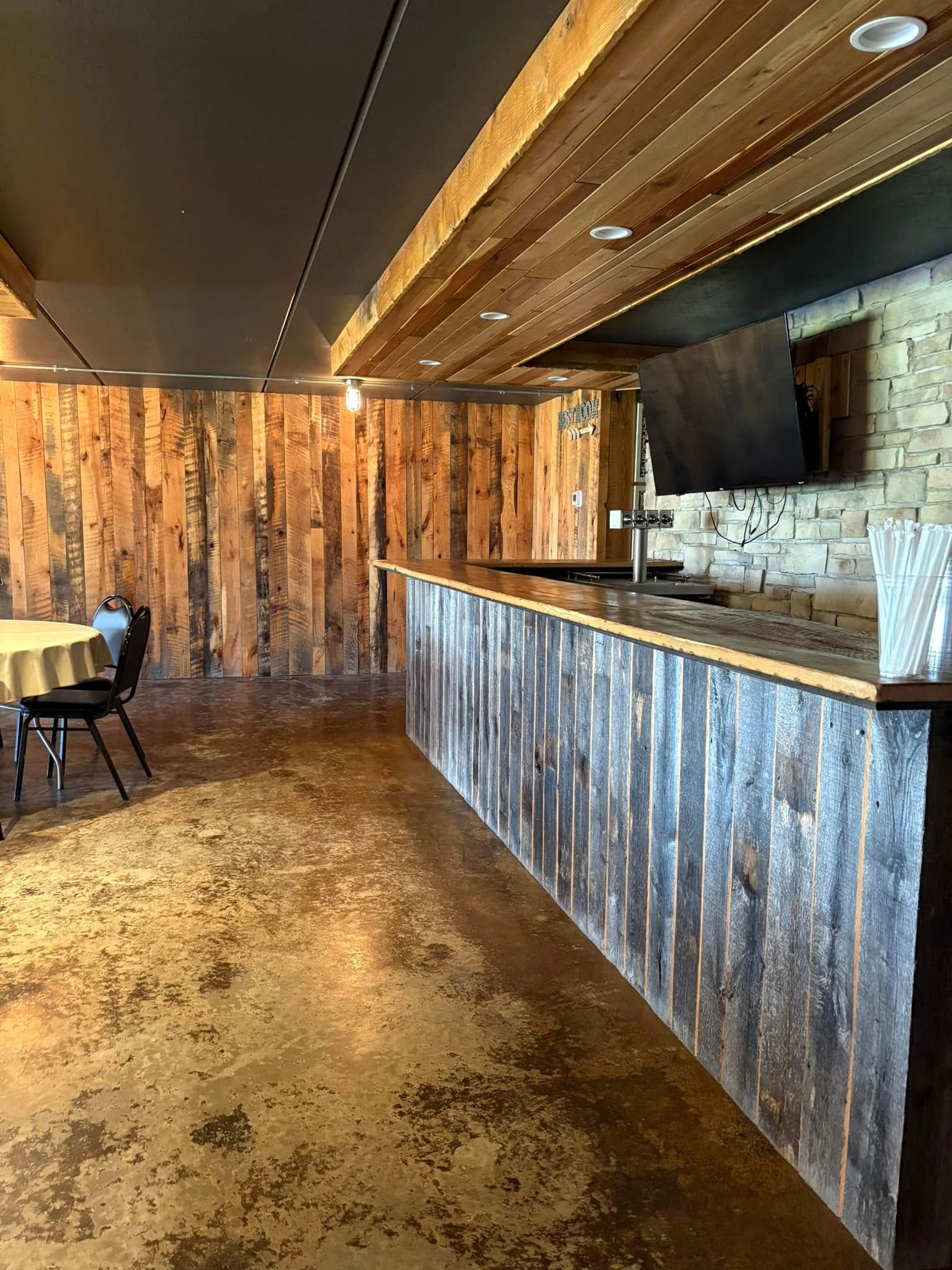 There is a long wooden counter in the middle of the room.