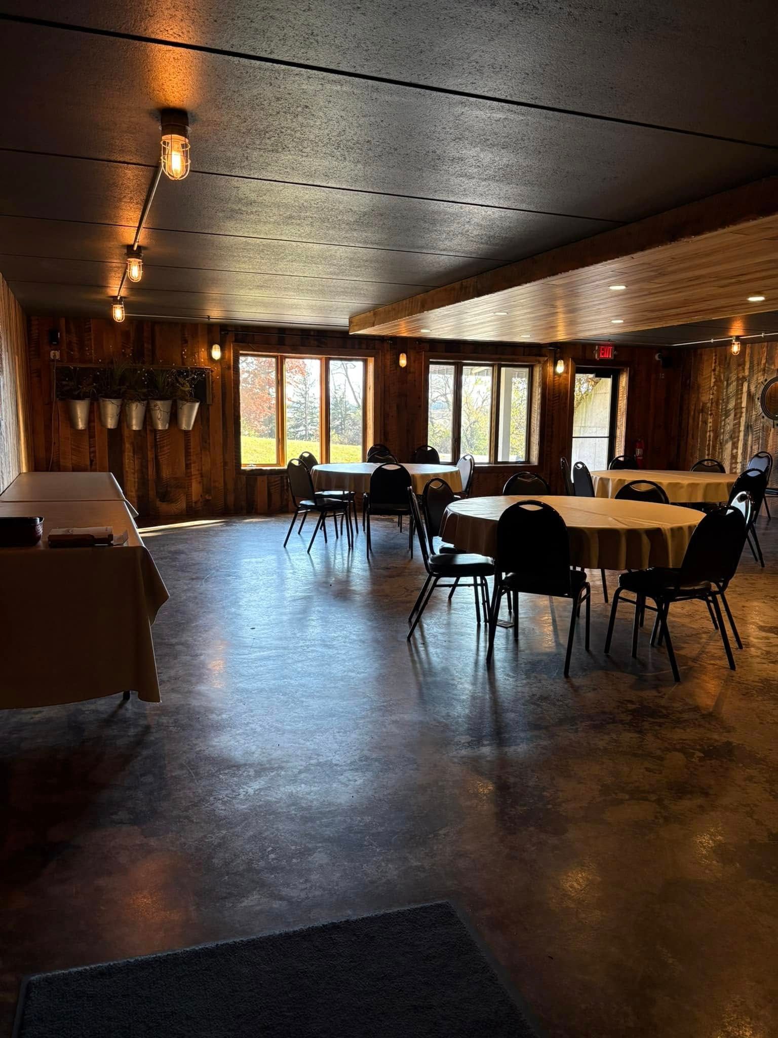 A large room with tables and chairs in it.