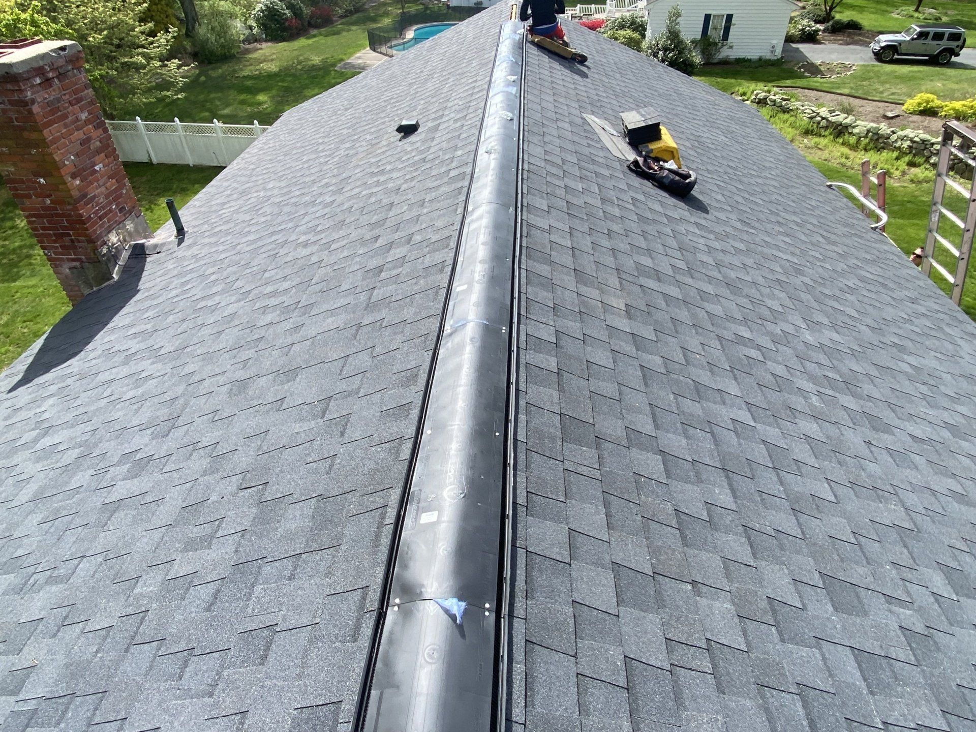 bluish gray roof with maroon brick chimney