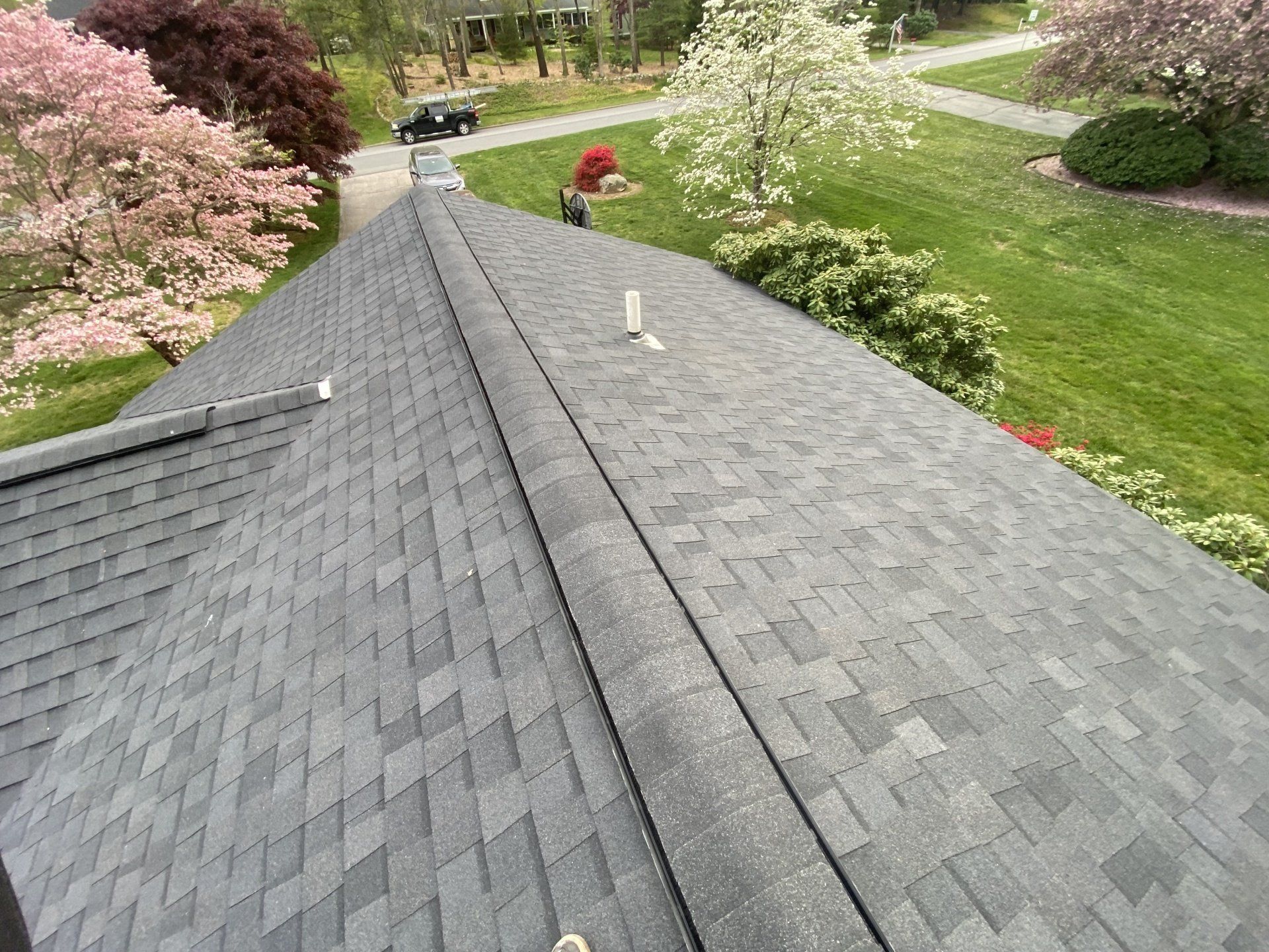 top view of gray roof with beautiful lawn