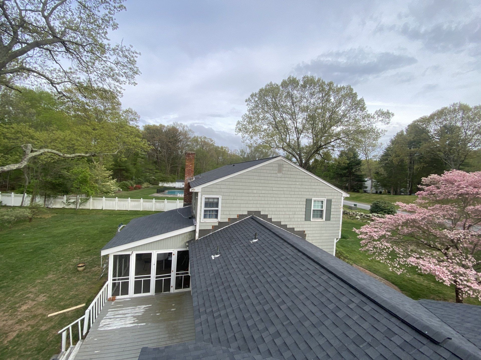 cream house with bluish gray roof