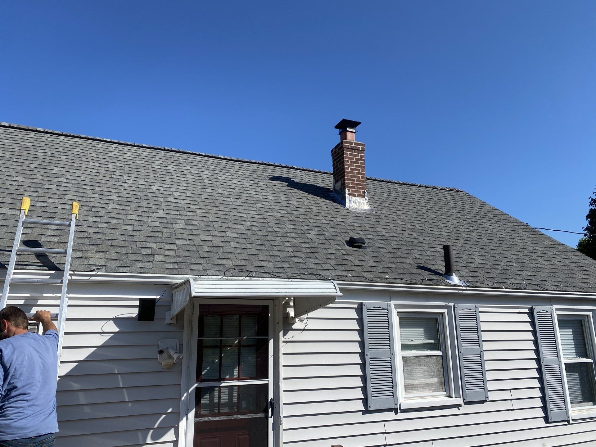 gray roof with brown brick chimney