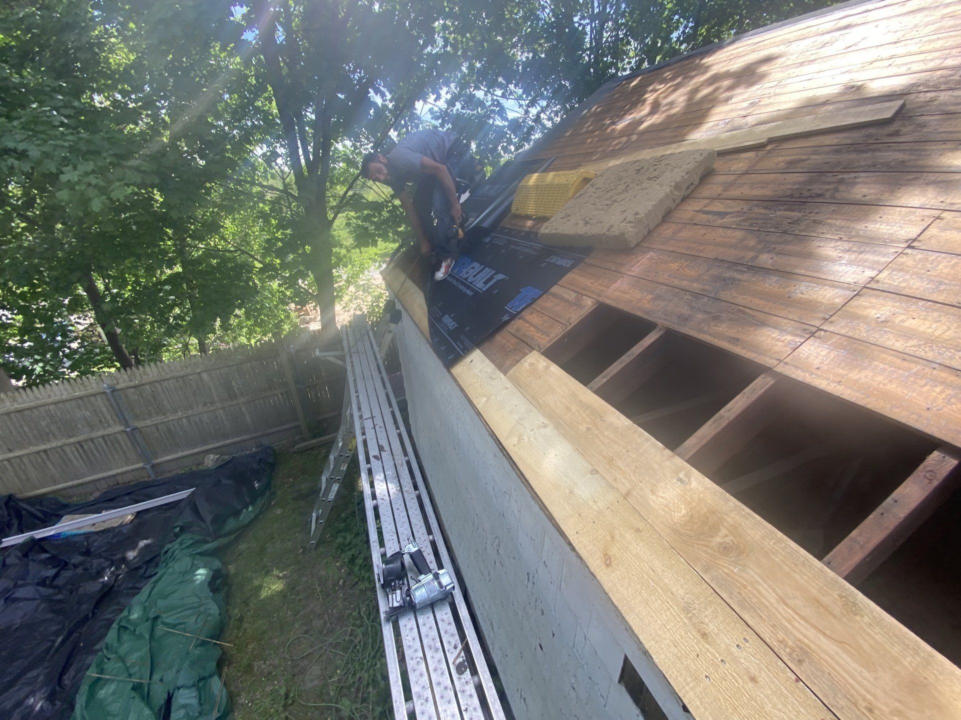 smiling man working on roof